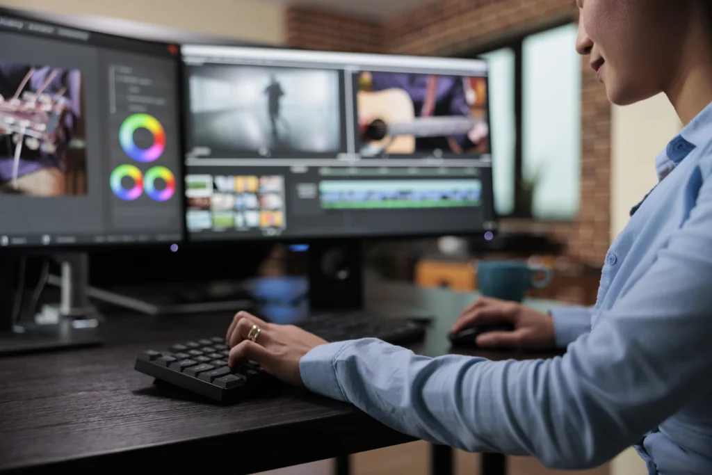 Video editor making creative editing decisions at a dark editing-suite workstation