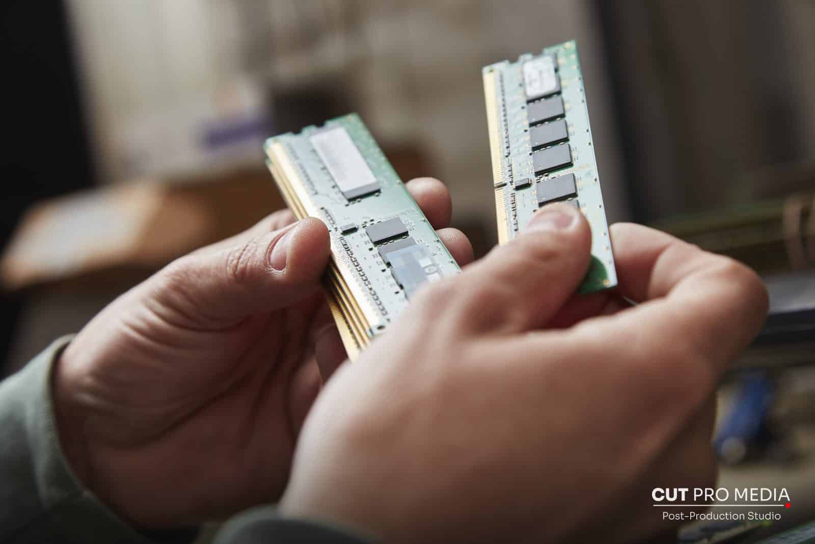 Hands holding two computer memory modules