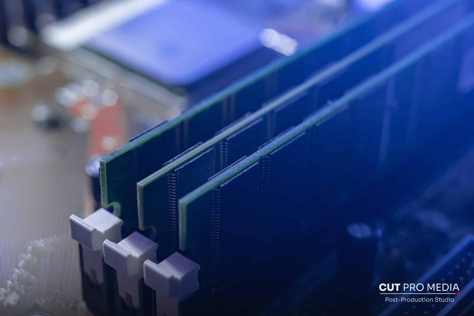 Close-up of RAM modules installed in a motherboard under blue light