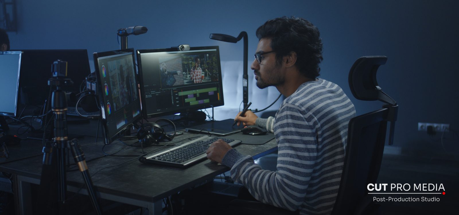 Video editor working on a dual-monitor editing workstation