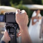 Wedding videographer filming the bride and groom with a camcorder